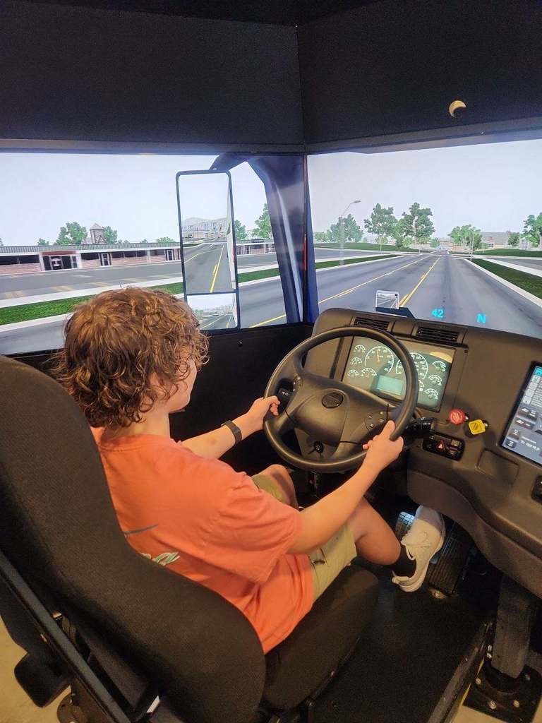 student driving virtual reality truck